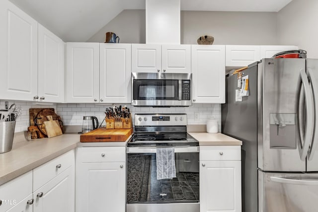 kitchen with stainless steel appliances, tasteful backsplash, light countertops, and white cabinetry