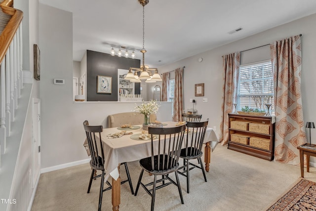 dining space featuring light carpet, baseboards, and visible vents