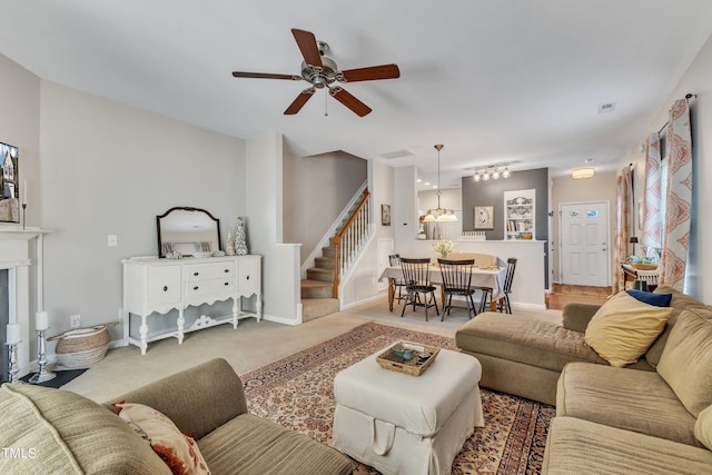 living area with carpet, a fireplace, stairway, and baseboards