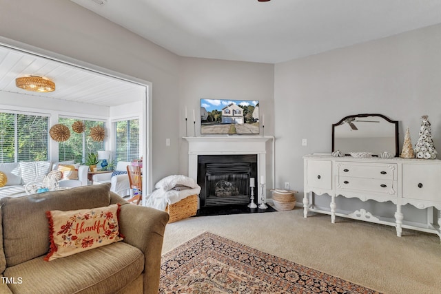 carpeted living room with a fireplace with flush hearth