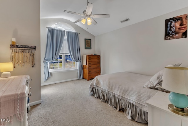 carpeted bedroom featuring a ceiling fan, visible vents, vaulted ceiling, and baseboards