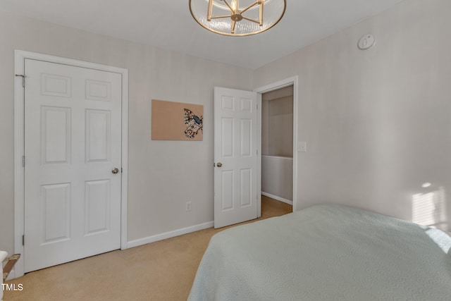 carpeted bedroom with baseboards and a notable chandelier