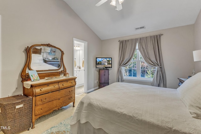 bedroom featuring light carpet, visible vents, ceiling fan, ensuite bath, and vaulted ceiling