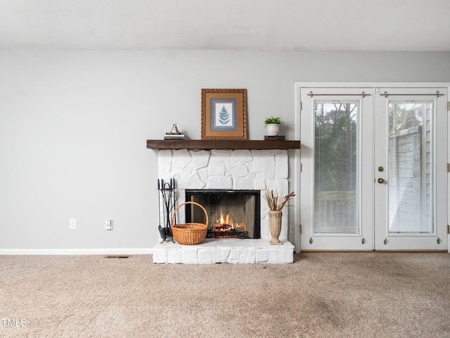 interior space featuring french doors, visible vents, a fireplace, and baseboards