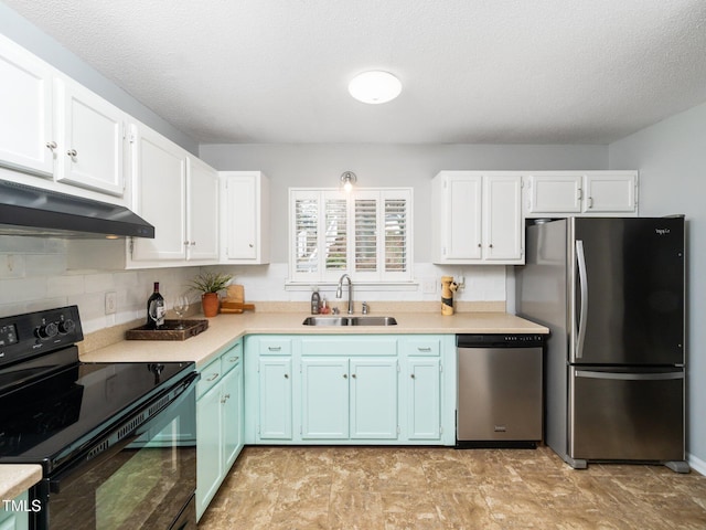 kitchen featuring appliances with stainless steel finishes, a sink, white cabinets, and under cabinet range hood