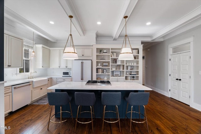 kitchen with white appliances, a kitchen island, a sink, light countertops, and beamed ceiling