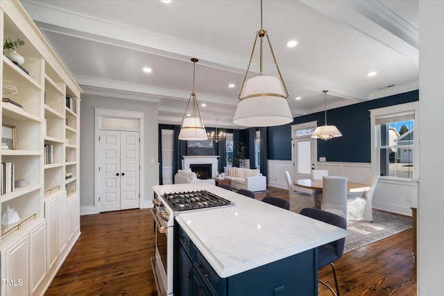 kitchen featuring white gas range oven, wainscoting, dark wood-style floors, blue cabinetry, and beam ceiling