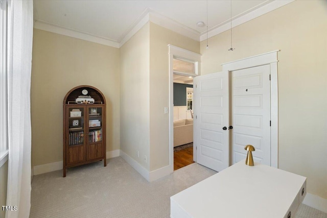 office featuring attic access, light carpet, crown molding, and baseboards