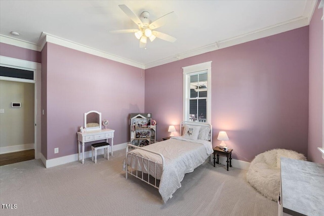 carpeted bedroom with baseboards, ornamental molding, and ceiling fan