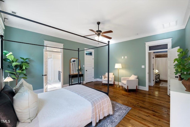 bedroom featuring visible vents, crown molding, baseboards, and wood finished floors