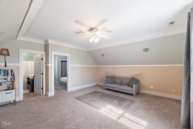 living area with light carpet, visible vents, vaulted ceiling, and a ceiling fan