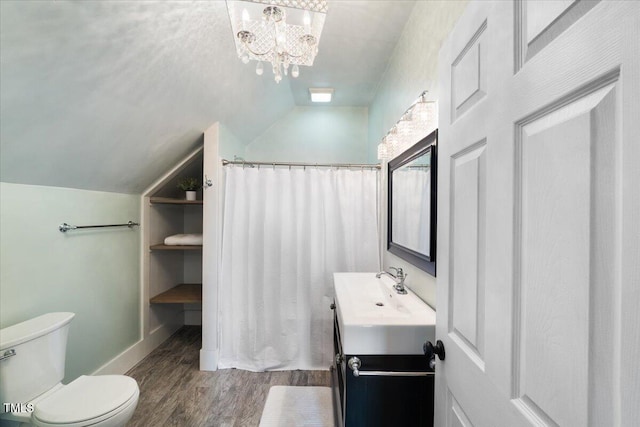 full bathroom featuring a shower with shower curtain, lofted ceiling, toilet, wood finished floors, and vanity