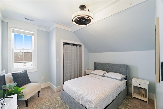 carpeted bedroom featuring lofted ceiling, visible vents, and baseboards