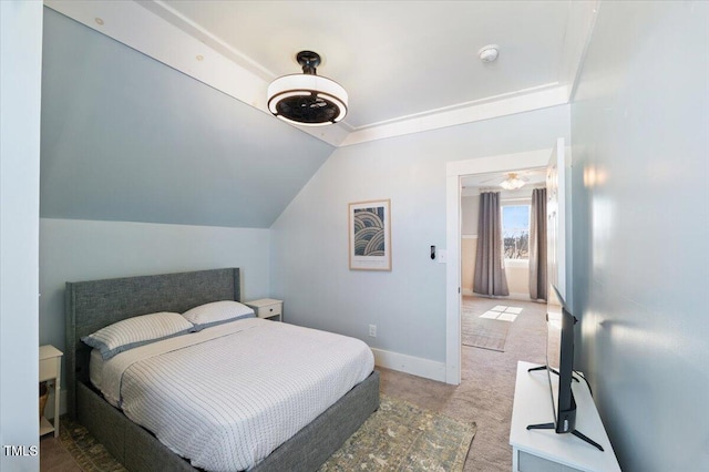 bedroom featuring lofted ceiling, carpet flooring, and baseboards