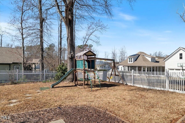 view of jungle gym featuring fence private yard and a residential view