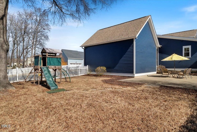 exterior space with a patio area, fence, and a lawn