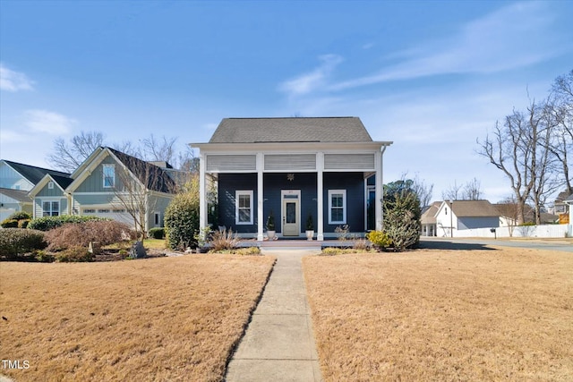 bungalow-style home with covered porch and a front lawn