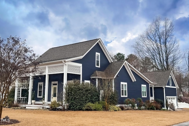 view of front of house with a porch and roof with shingles