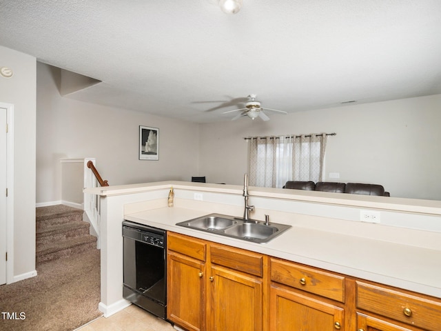 kitchen with light carpet, a sink, light countertops, brown cabinets, and dishwasher