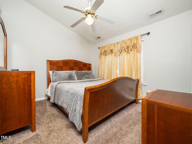 bedroom featuring carpet, visible vents, a ceiling fan, vaulted ceiling, and a textured ceiling