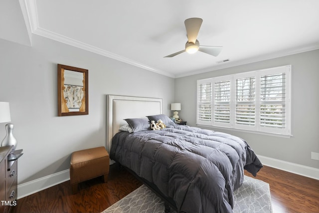 bedroom with visible vents, baseboards, wood finished floors, and ornamental molding