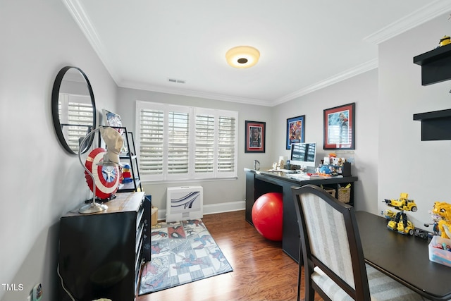 home office featuring visible vents, ornamental molding, baseboards, and wood finished floors