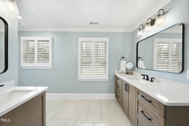 full bath with two vanities, ornamental molding, visible vents, and a sink