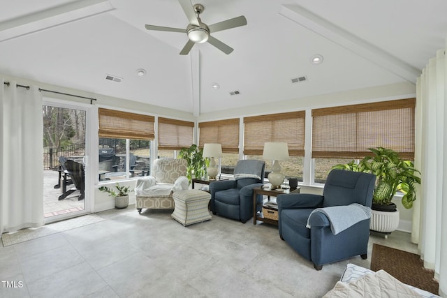 sunroom featuring visible vents, lofted ceiling, and ceiling fan