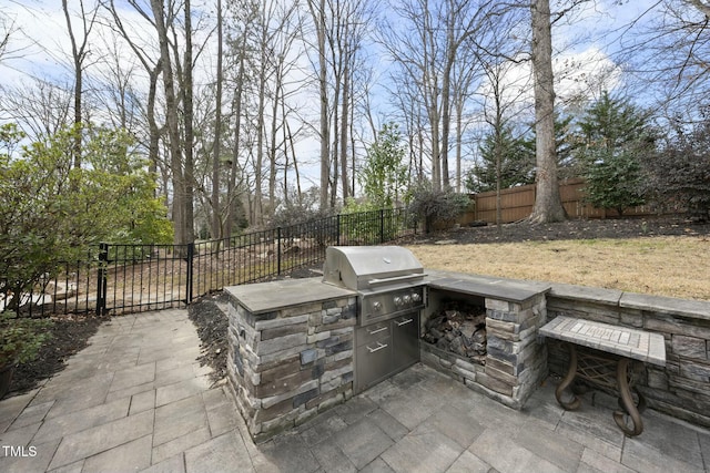 view of patio with area for grilling and fence private yard