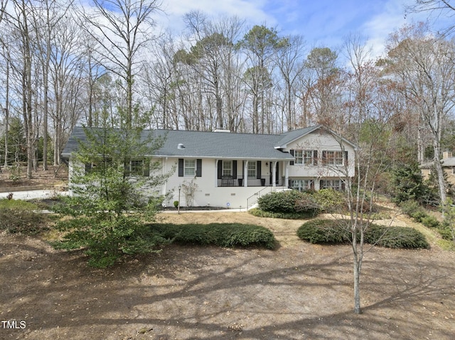 tri-level home featuring roof with shingles