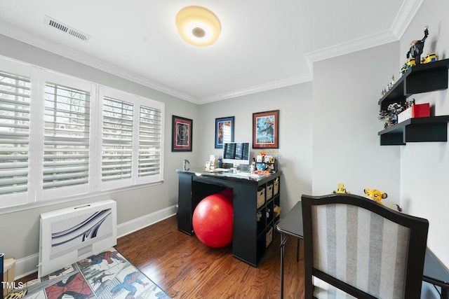 office space with visible vents, ornamental molding, heating unit, wood finished floors, and baseboards