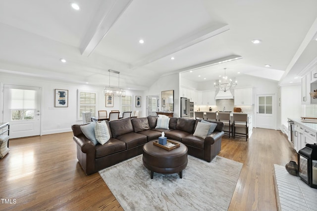 living area with lofted ceiling with beams, wood finished floors, recessed lighting, an inviting chandelier, and baseboards