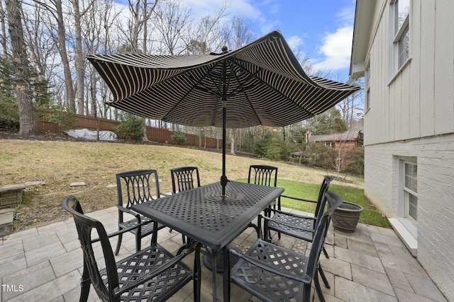 view of patio / terrace with outdoor dining space and fence