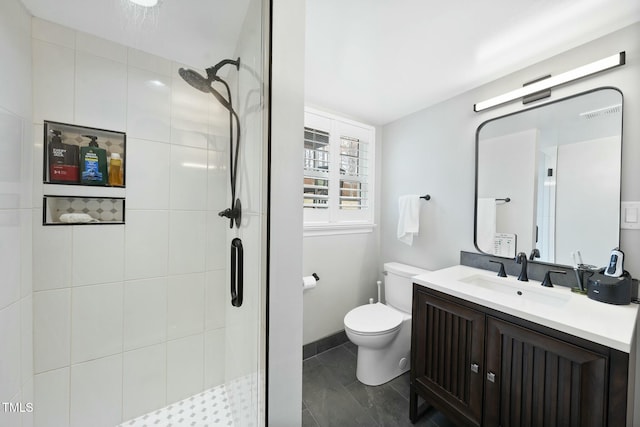 bathroom with tile patterned floors, toilet, a stall shower, and vanity