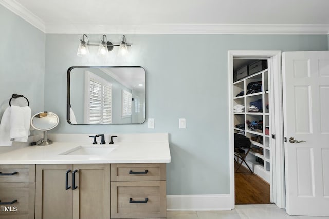 bathroom with vanity, baseboards, and ornamental molding