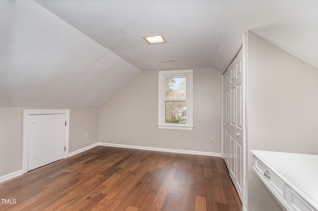 bonus room featuring lofted ceiling, baseboards, and wood finished floors