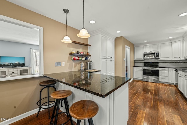 kitchen featuring white cabinetry, appliances with stainless steel finishes, backsplash, and dark wood-style flooring