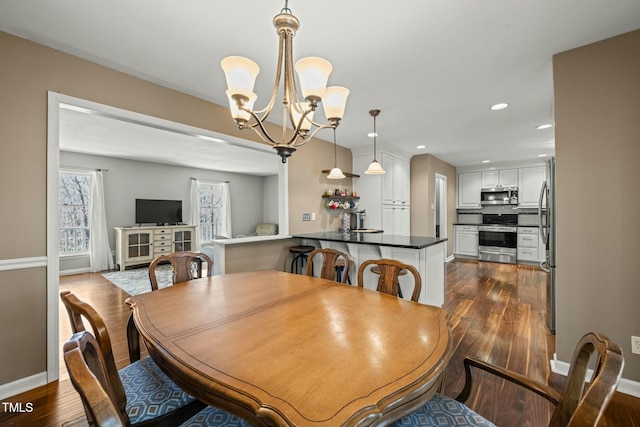 dining room featuring dark wood-style floors, baseboards, a notable chandelier, and recessed lighting