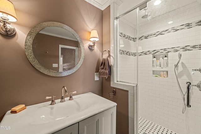 full bathroom with crown molding, a shower stall, and vanity