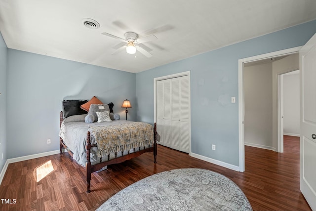 bedroom featuring a closet, wood finished floors, visible vents, and baseboards