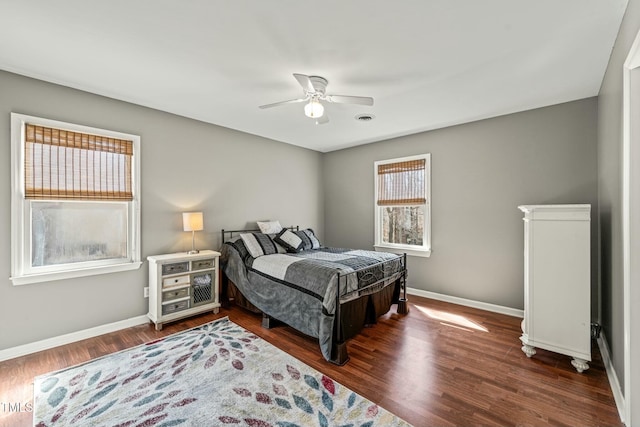 bedroom with dark wood finished floors, baseboards, and ceiling fan