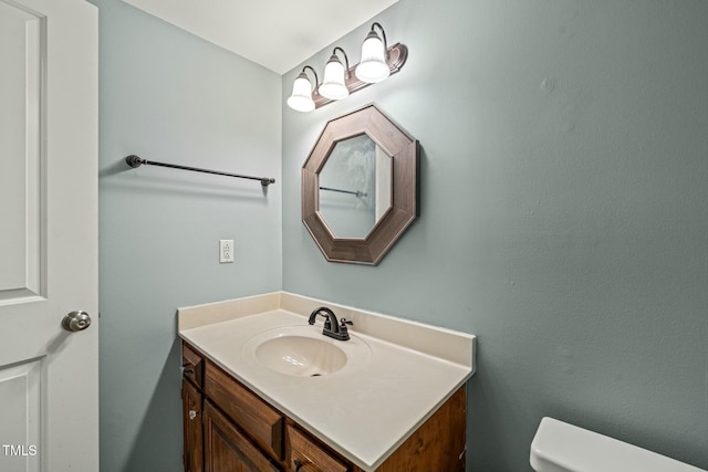 half bathroom featuring toilet and vanity