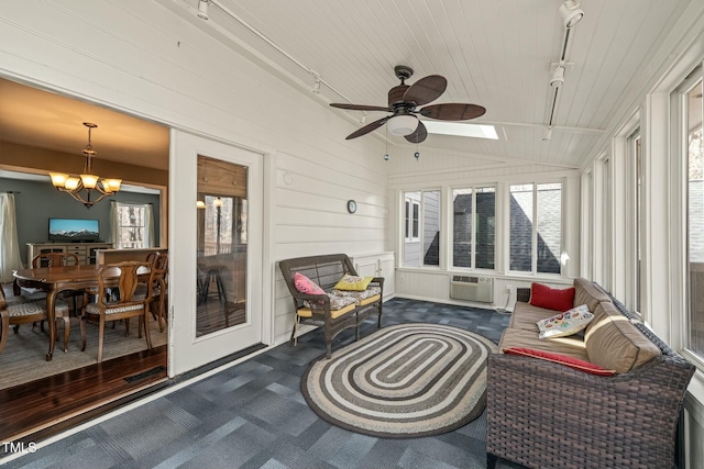 sunroom featuring cooling unit, vaulted ceiling, and ceiling fan with notable chandelier