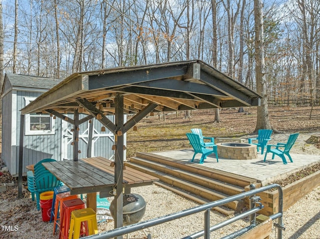 view of home's community featuring a fire pit, a shed, and an outbuilding