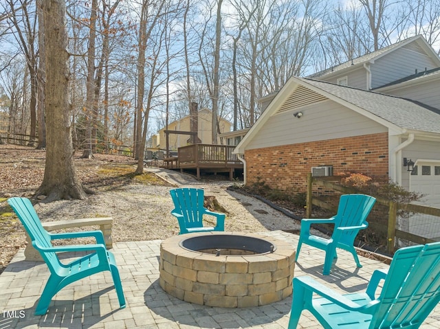 view of patio / terrace with an outdoor fire pit and a deck