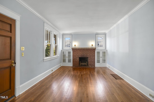 unfurnished living room with a brick fireplace, visible vents, crown molding, and baseboards