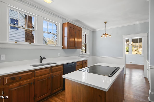 kitchen featuring a center island, dark wood-style flooring, crown molding, a sink, and black appliances