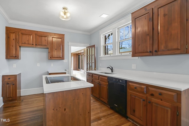 kitchen with dark wood-style flooring, a center island, crown molding, black appliances, and a sink