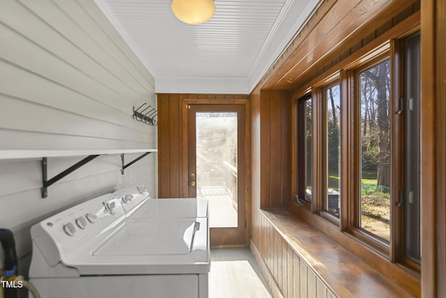 laundry room featuring crown molding, laundry area, plenty of natural light, and washer and dryer