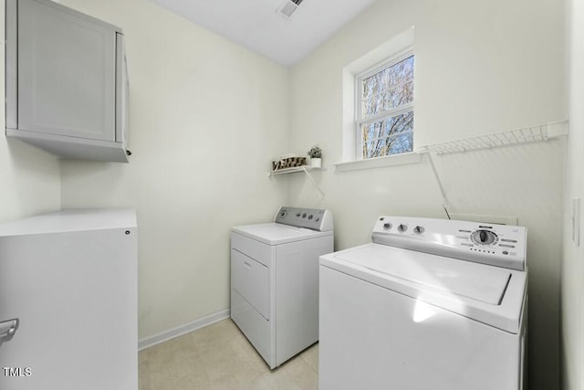 laundry room featuring washer and dryer, cabinet space, visible vents, and baseboards